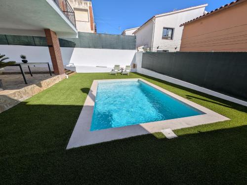 a swimming pool in the backyard of a house at VILLA Pinemar & Relax in Pineda de Mar