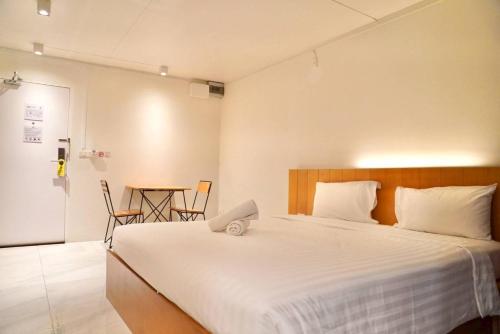 a bedroom with a bed with a laptop on it at Viewplace Hotel & Residence Lat Phrao 130 in Bangkok