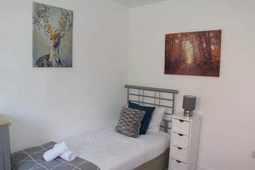 a bedroom with a bed and a painting on the wall at K Suites - Station Road 2 in Hinckley
