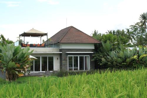 a small house with a gazebo on top of it at The Samara Villas & Restaurant in Ubud