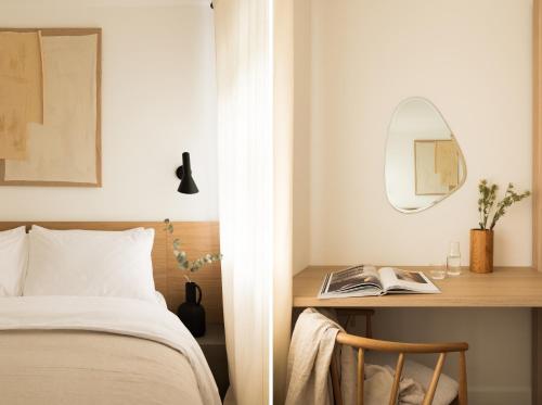 a bedroom with a bed and a desk with a mirror at The Japandi Escape - 2BR Duplex in Central Oxford in Oxford
