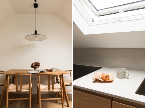 a room with a table and a skylight at The Japandi Escape - 2BR Duplex in Central Oxford in Oxford