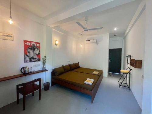 a room with a bed and a chair in it at Casa Moon Trincomalee Beach House in Trincomalee