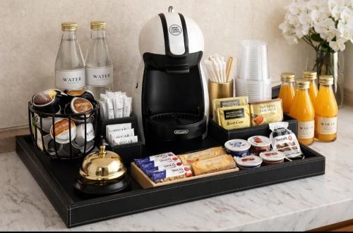 a tray with a coffee maker and other food items at Catherine Suite in SantʼEufemia Lamezia