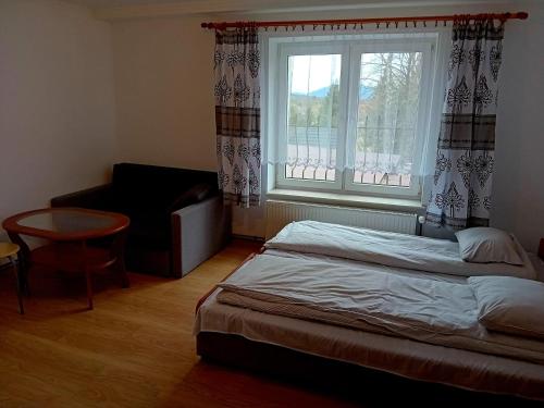a bedroom with a bed and a window at BERDO Noclegi i restauracja in Wetlina