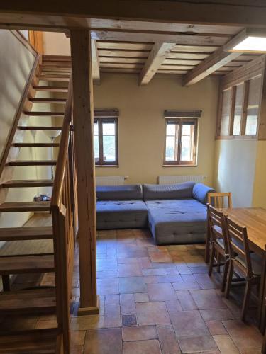 a living room with a couch and a table at Pod modříny in Adršpach