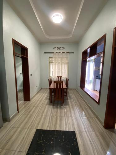 a dining room with a table and chairs at B-luxury stay in Ruhengeri