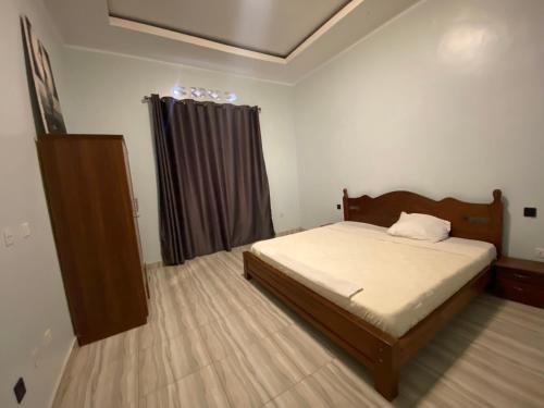 a small bedroom with a bed and a window at B-luxury stay in Ruhengeri