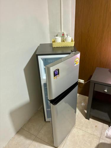 a small refrigerator in a kitchen with a counter at Farang house in Pattaya