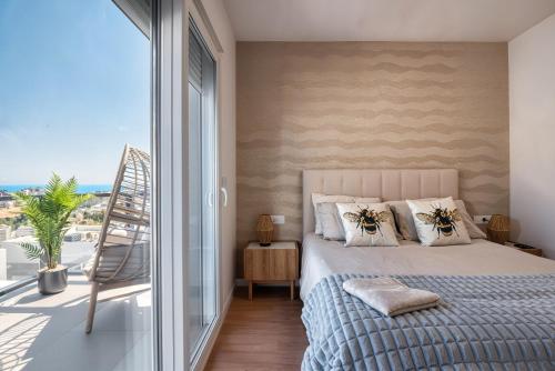 a bedroom with a bed and a large window at Stunning House, 3BR, HOT TUB, WIFI, Parking in Finestrat