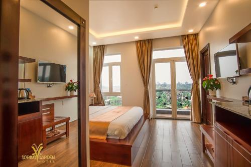 a bedroom with a bed and a large window at Spring Garden Hotel in Long Khanh