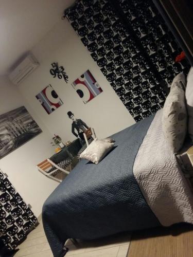 a bedroom with a bed with a black comforter at Affittacamere Erbagatta in Erba