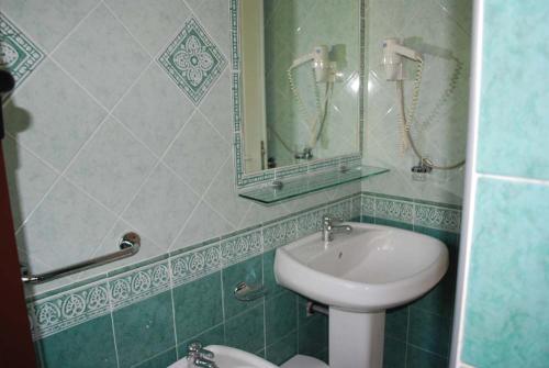 a bathroom with a sink and a mirror at Residence la Chimera in Villasimius