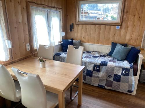 a bedroom with a bed and a table and chairs at Zillerstadl - 5 Sterne Erlebnisresort Aufenfeld, Aschau in Aschau