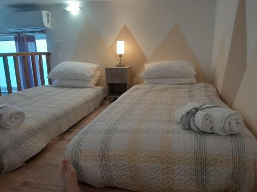 two beds sitting next to each other in a bedroom at The Getaway in Agia Marina Nea Kydonias
