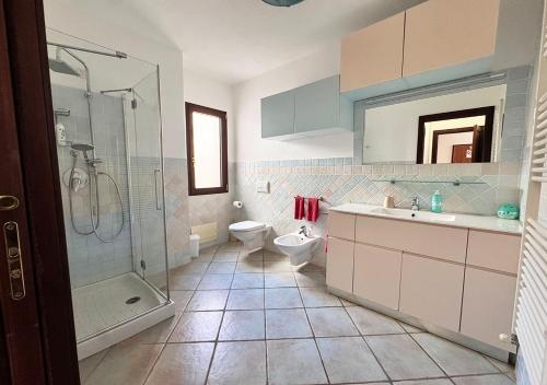 a bathroom with a shower and a sink and a toilet at Oasi della pace in La Maddalena