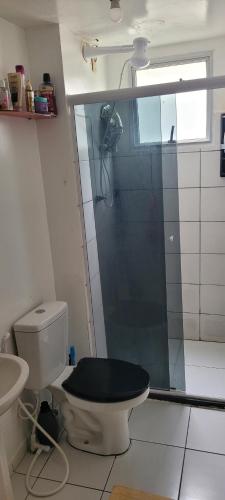 a bathroom with a toilet with a glass shower at Joy Hostel in Salvador
