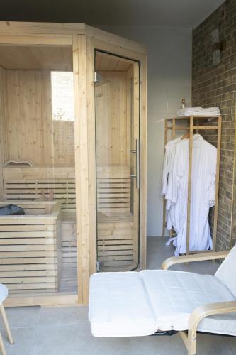 a room with sliding glass doors and a white bed at Garden Spa in Caudebec-lès-Elbeuf