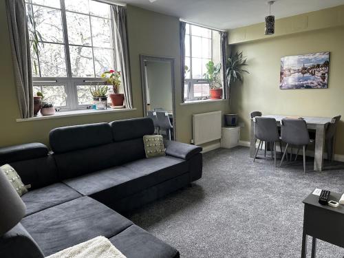 a living room with a couch and a table at Superb Peaceful 1 bed apartment in St George. in Bristol