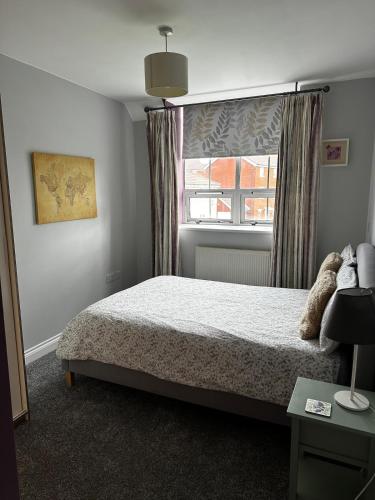 a bedroom with a bed and a window at Superb Peaceful 1 bed apartment in St George. in Bristol