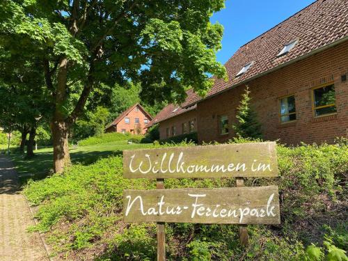 a sign in front of a building that says will summon up natures treasures at Haus 25 im Natur Ferienpark, Erlebnisurlaub mit Action, Radfahren und Wanderabenteuern im Grünen in Nieheim