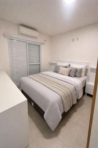 a white bedroom with a large bed in it at Apartamento in Socorro