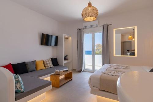 a living room with a couch and a living room with a couch at Aqua Cozy Suites in Perissa