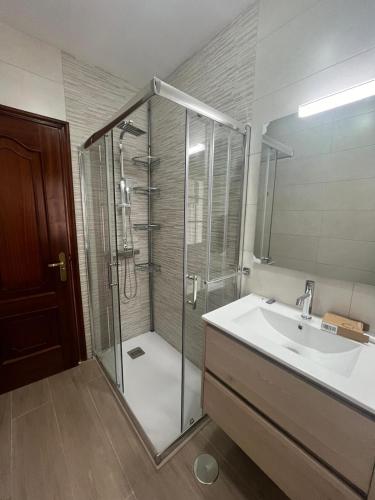 a bathroom with a shower and a sink at Rúa da Igrexa Miño in Miño