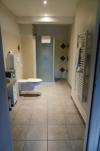 a bathroom with a sink and a toilet in a room at Hôtel Bistrot Les Tanins in Saint-Antoine