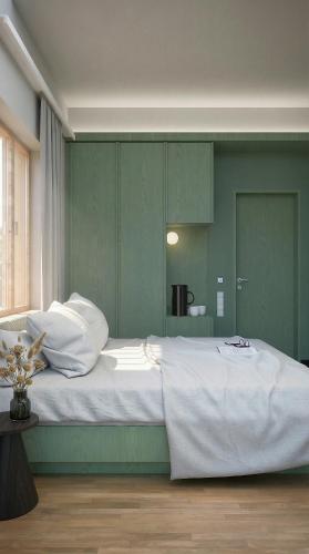 a bedroom with a large bed with green walls at Vila Soča in Bovec