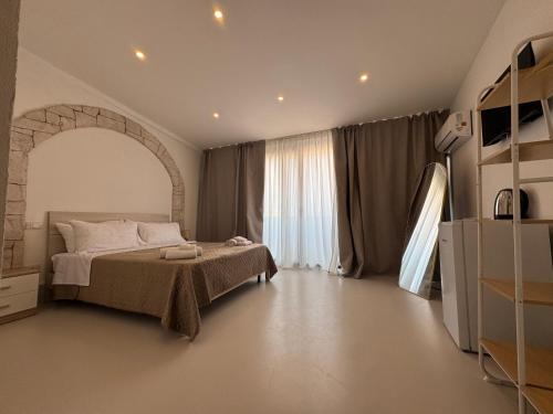 a bedroom with a bed and a large window at Bella Gallery Terrasini in Terrasini