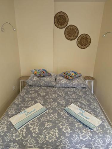 a bed with two certificates on top of it at Mały Domek in Szczecinek