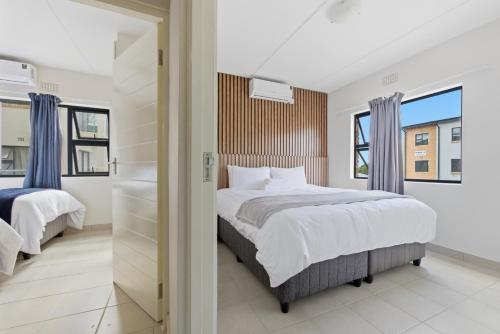 a bedroom with two beds and a window at Gae La Rona in Gaphatshwe