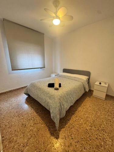 a bedroom with a bed and a ceiling fan at Casa en la montaña con jacuzzi exterior y piscina in Alcántara de Júcar