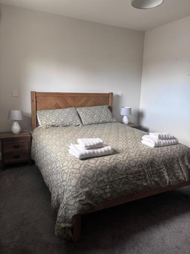 a bedroom with a bed with two pillows on it at Moate View Lodge in Ballymore Eustace
