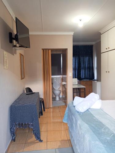 a room with two beds and a table and a bathroom at DAX BnB in Cedarville