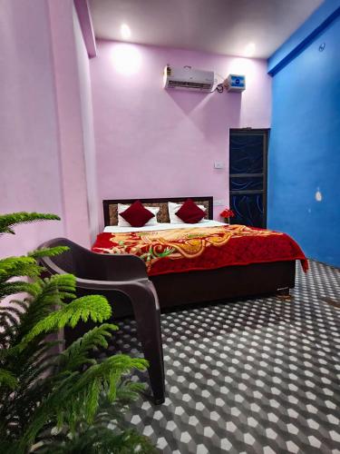 a bedroom with a bed with red pillows at Shree krishna guest House near Ram mandir in Ayodhya