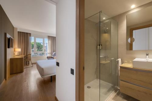 a bathroom with a glass shower and a sink at Hotel SB Corona Tortosa in Tortosa