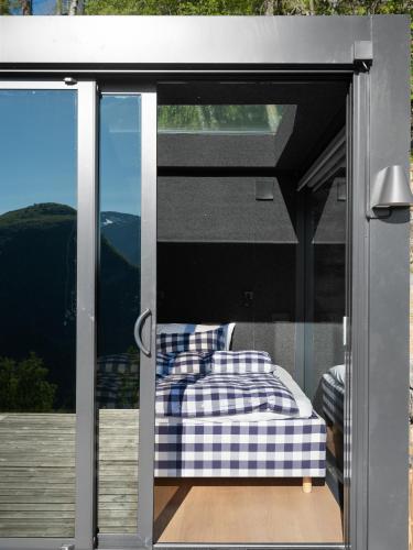 a bedroom with a bed on a balcony at Kilsti Lodge in Eidsdal