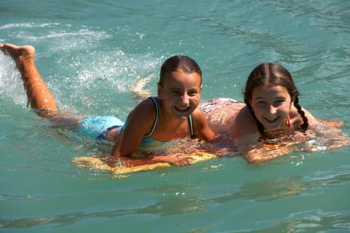 two girls swimming in the water in the water at Die Lilie / Hotel Garni in Reutte