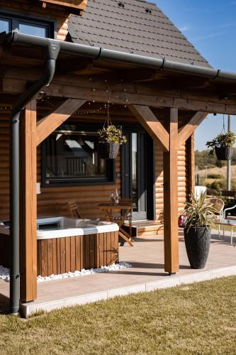 a wooden pergola on a patio of a house at BeLaWood in Egerszalók