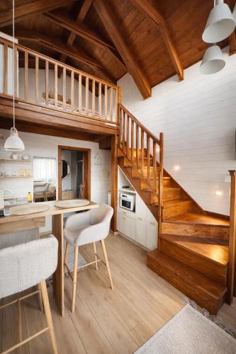 a kitchen with wooden stairs and a table and chairs at BeLaWood in Egerszalók