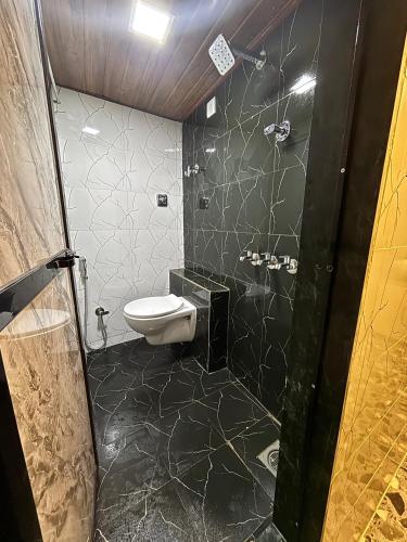 a bathroom with a shower and a toilet in it at Lucky beds pg and hostel in Mumbai