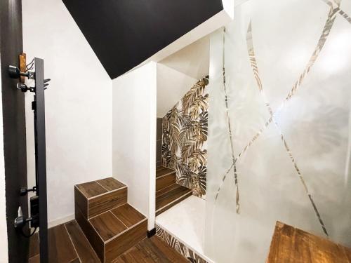 a staircase in a house with a mural on the wall at Studio Riom - Proche gare SNCF in Riom