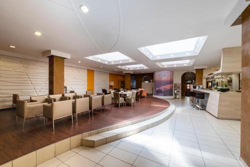 a dining room with tables and chairs and skylights at Star Hotel by Mellow Mood Hotels in Budapest