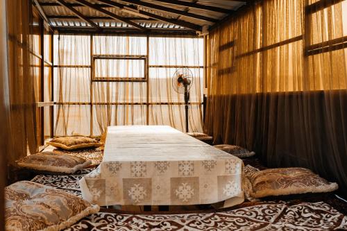 a room with two beds and a table in it at KokTau in Kokshetau
