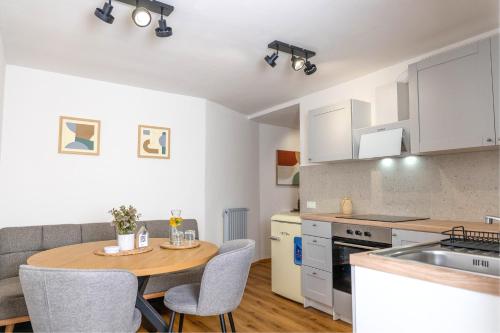 a kitchen and dining room with a table and chairs at Red Maple Apartments in Maribor