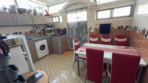 a kitchen with a table and chairs in a room at Imi Ouaddar Sea View Retreat in Agadir