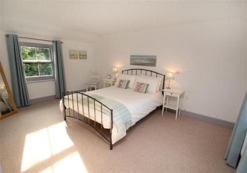 a bedroom with a large bed and a window at 3 Bed in Gower oc-hh472 in Cheriton