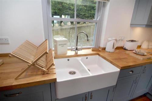a kitchen counter with a sink and a window at 3 Bed in Gower oc-hh472 in Cheriton